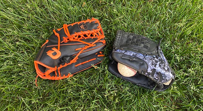 Two baseball mitts and a baseball