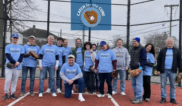 Ed Randall (kneeling) with friends posing for a photo after having a catch