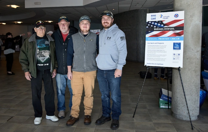 Four men attend a Fans for the Cure health fair at the Cradle of Aviation Museum on Veterans' Day 2023.