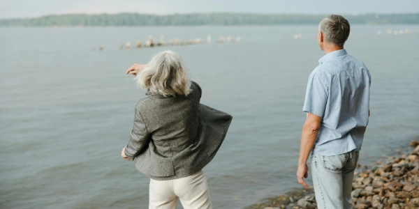 A couple skipping stones on a beach