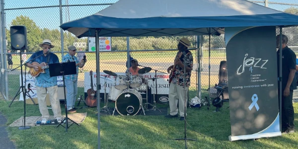 Musicians from Jazz for Prostate Cancer performing at a baseball field