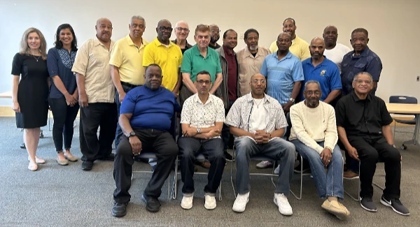 A number of men and a few women gather for a photo at a prostate cancer awareness event