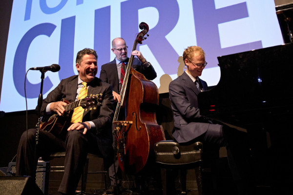 The John Pizzarelli Trio performing at the Fans for the Cure's Holiday Spectacular